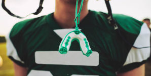 Football player with mouth guard.