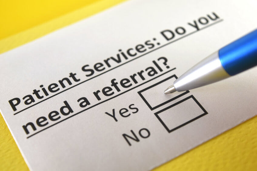 A photo illustration of a card that reads Patient Services. Do You Need a Referral? Yes? No?