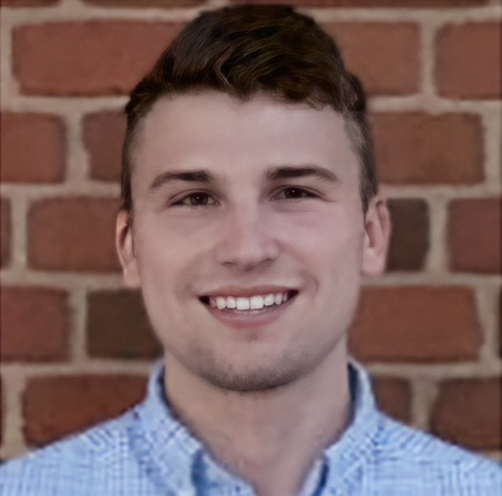 A photo of Dr. Chris Hackett, smiling casually.